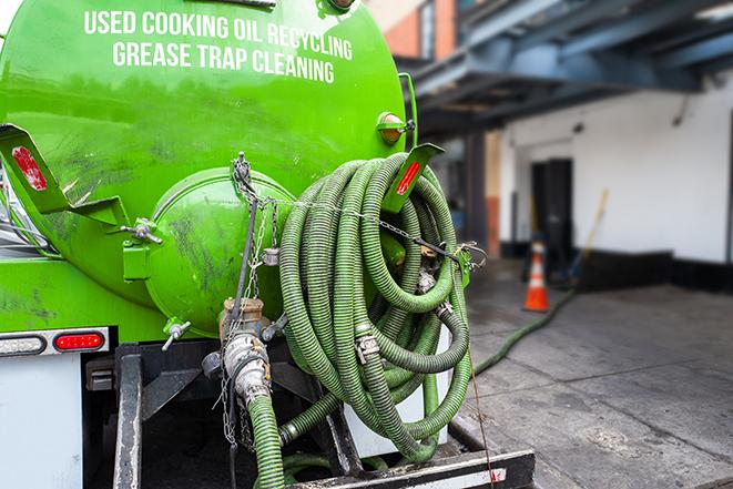 grease trap pumping truck in action in Caledonia